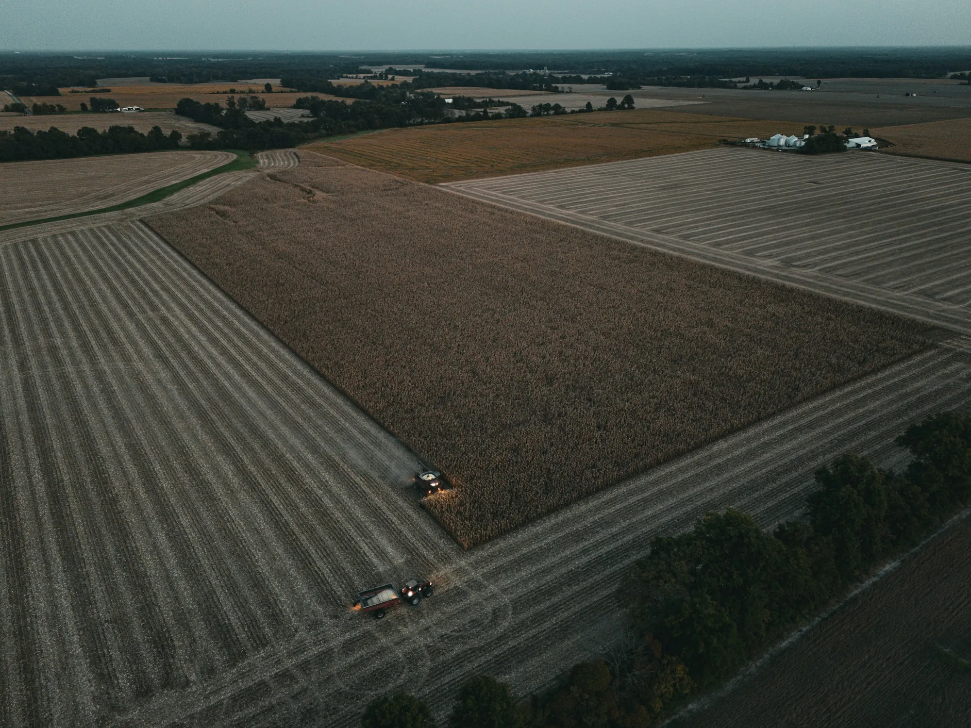 Aerial view of a combine harvesting a large field